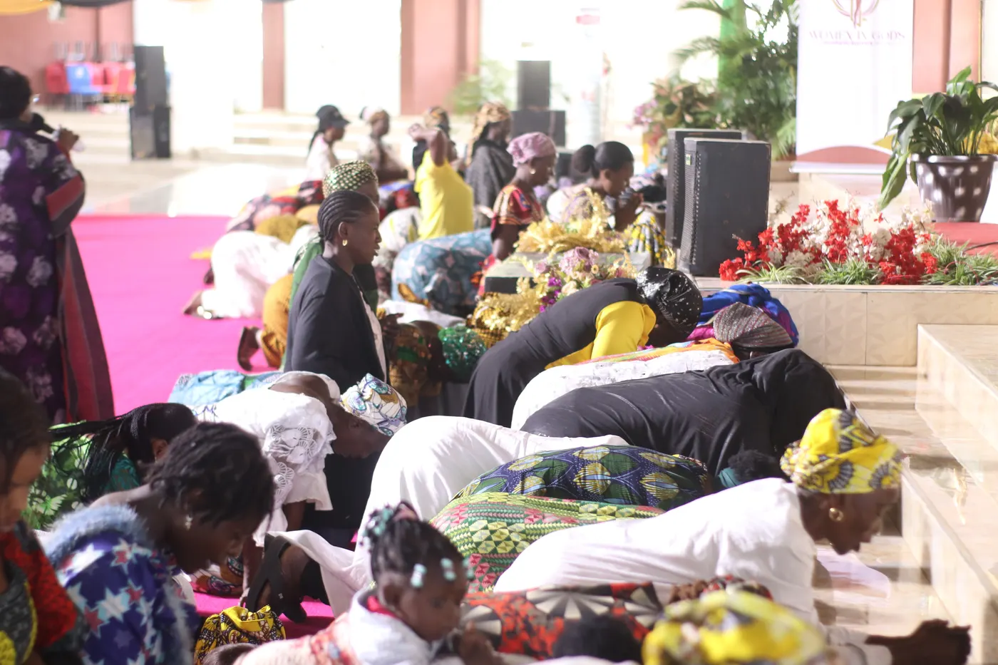 Women of the Alliance prostrate in prayer together.